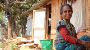 A homeowner outside of her temporary shelter