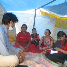 A helpdesk volunteer listening to displaced people