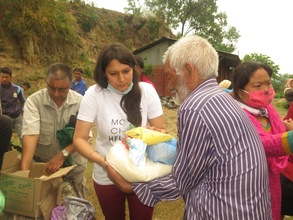Volunteers distributing supplies in a village.