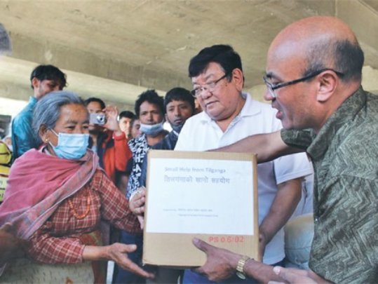 Dr. Ruit distributing relief aid after the quake