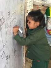 Young girl writes on ETC-provided white board