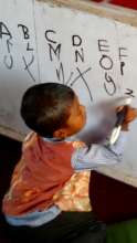 Pre-primary student practices his letters