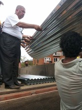 Helping locals put roof on their temporary shelter