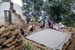 Temporary tent being set up next to destroyed HP