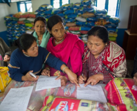 A women's committee signs for food packages