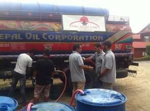 Filling up 55 gallon drums for distribution