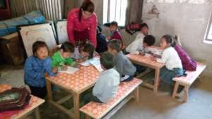 Teacher checking Homework in lower class