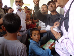 Kids receiving  cash for dress and stationary