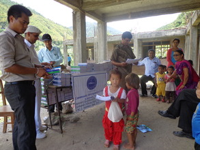 School Chairman distributing stationery.