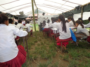 Teacher teaching under the tent.