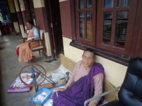 An old woman making thread