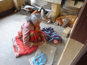 An old woman twisting  thread for oil lamp