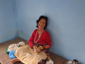 An old woman  taking  take care of her dishes.