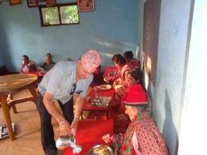 CDC Chairperson preparing food Milk  to the old