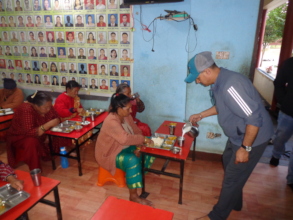 Chairman pouring milk to elderly