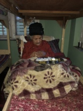 An old woman weak  in her bed