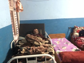 An old man having  a rest in his bed