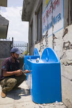 Rajendra, on the Splash-Nepal team, makes repairs