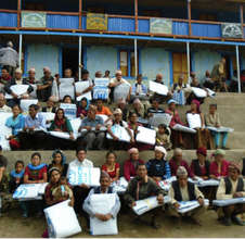 Villagers in Rakha gather to collect their tarps