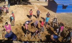 Community members volunteer and break ground