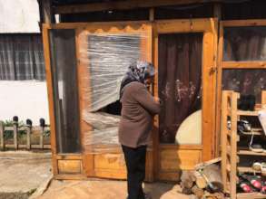 Grandmother Drita in front of her house