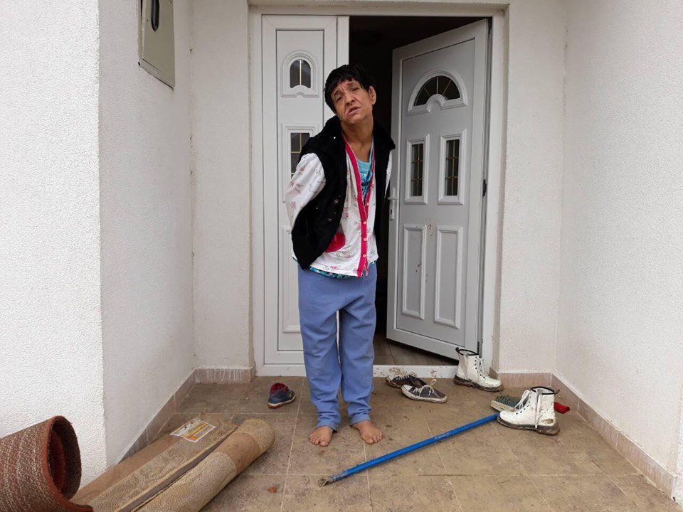 Mother Xhevahire in front of her house