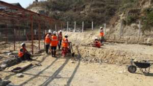 Workers clear site for a new school building