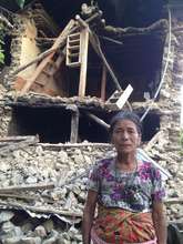 Women standing infront of her colapsed house