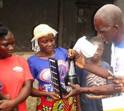 Village mother receiving her 560 lumens lantern