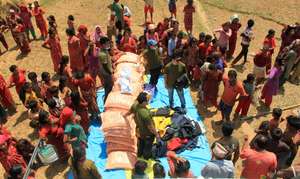 Tents and rice being distributed