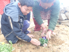 Planting flowers together at Laligurash School