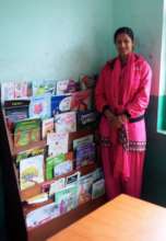 A teacher at a book rack at Bal Chandra School.