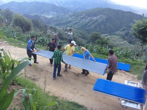 Families receiving roofing tin you provided