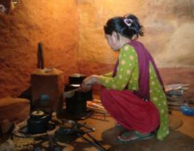 Improved cookstove being used (towards right)