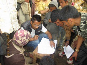 Forms being filled before relief distribution