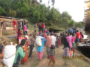 Villagers carry away their share
