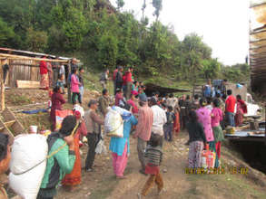 Villagers carry away their share