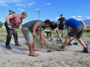 Mixing cement with spades and manpower