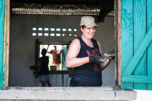 Sarah working on a window sill