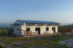 First school building with benches outside