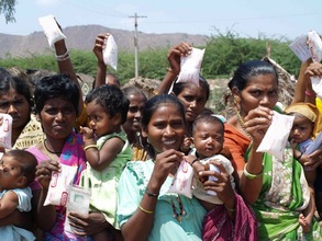 Milk distribution to babies in Rajarajeswari.