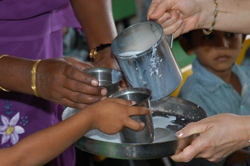 Distributing Milk to 1000 Slum Children