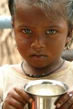 Slum girl holding a cup of milk