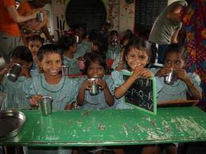 Girls drink their daily milk at our Kandrika liter
