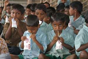 Boys drink milk at the Rajarajeswari literary cent