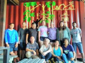 Tulane students posing in front of their work