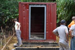 Wynne inspecting if container is well-positioned