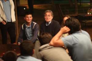 Students (in blue polos) discuss with participants