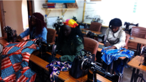 Amina, center, working in her tailoring class.