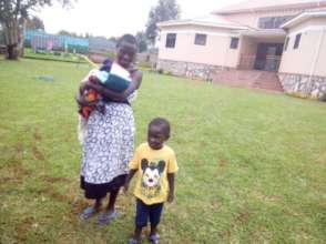 Toddler E with mother and baby sister